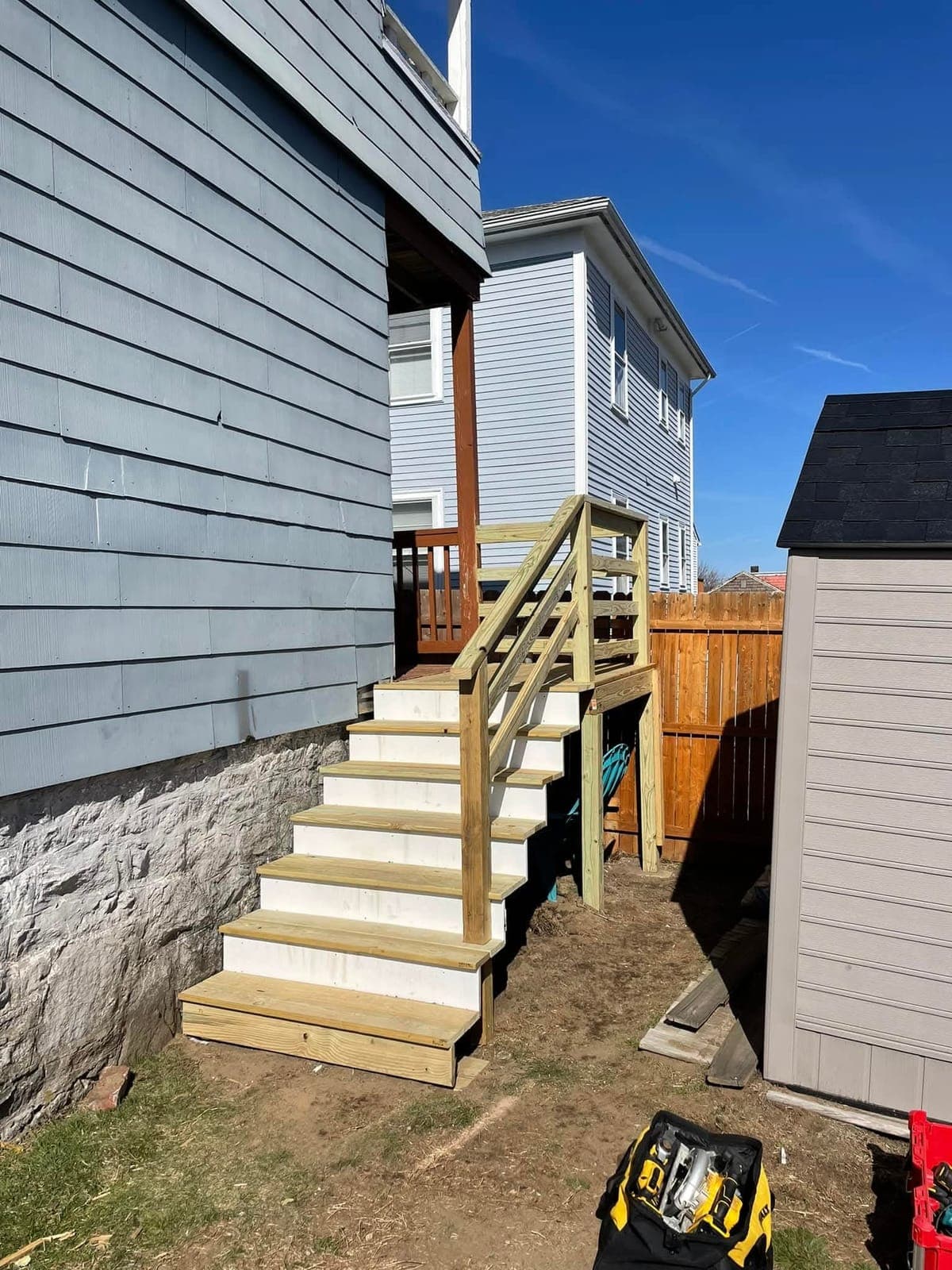 Rebuilt Deck Stairs & Landing after - Tore out a rotted side staircase and landing and rebuilt it in pressure-treated lumber with a new railing — safe, square, and built to last.