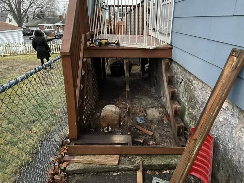 Rebuilt Deck Stairs & Landing before - Tore out a rotted side staircase and landing and rebuilt it in pressure-treated lumber with a new railing — safe, square, and built to last.